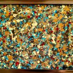 Abstract painting of dense paint splatters in gold, teal, red and cream in a gilt frame